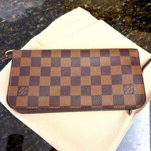 Like brand new!!! 
Louis Vuitton fold over /clutch wallet.
Comes with dust bag!